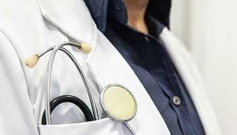 A close-up of a stethoscope in a doctor's pocket.